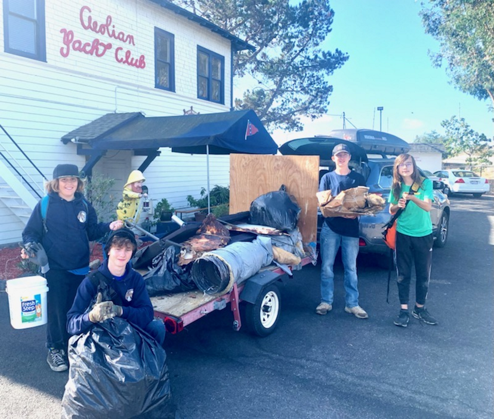 Scouts outside the Aeolian Yacht Club next to a trailer loaded with trash collected from the shoreline