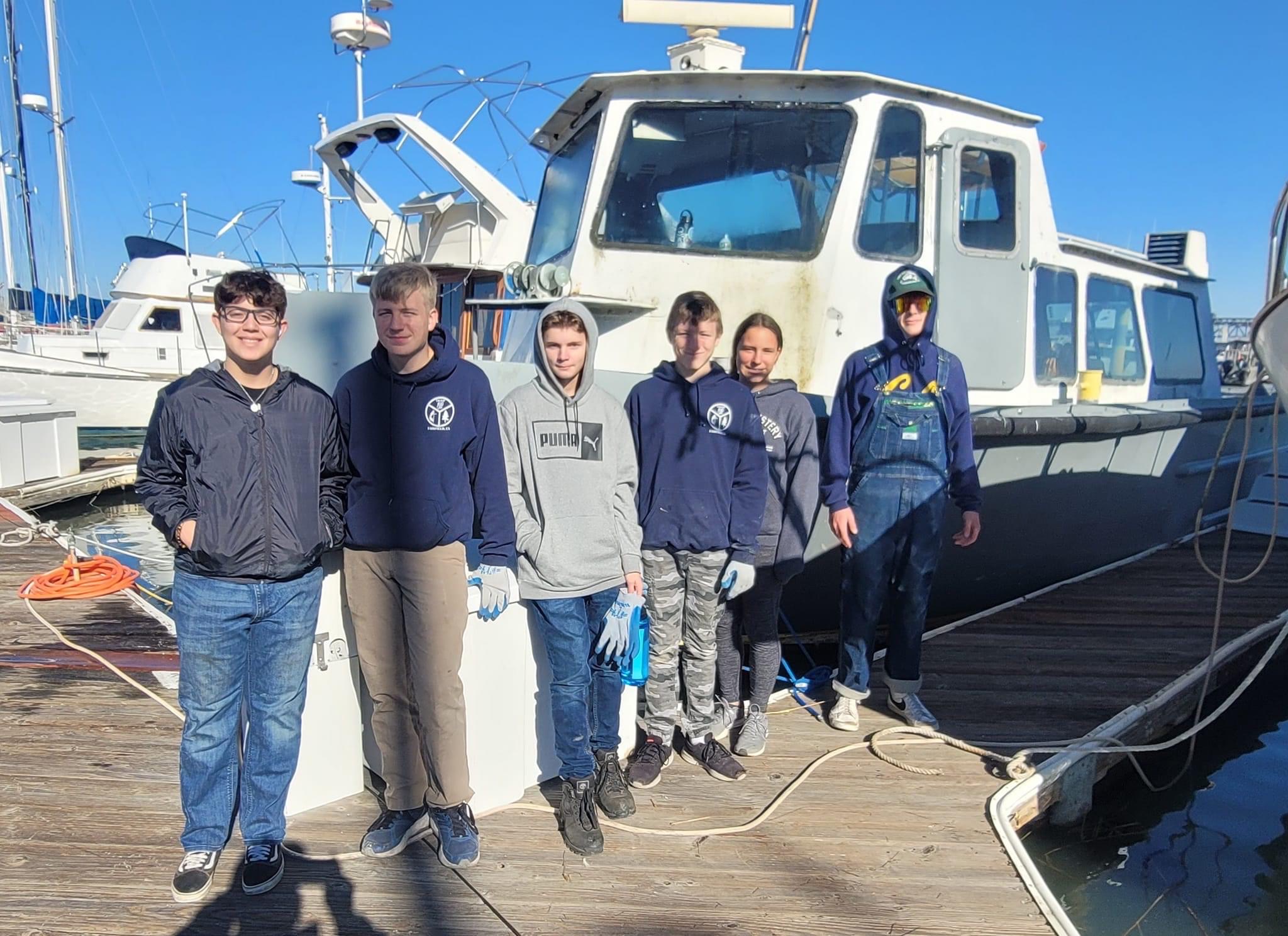 Ship 317 scouts standing in front of power boat